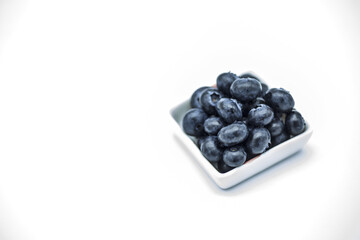 Square bowl Blueberries isolated on white background super closeup