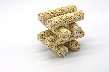 Crispy rice rollers stacked like a square tower on white background