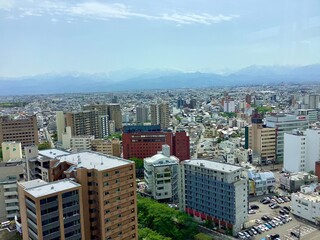 Fototapeta premium Scenery of Toyama city and Tateyama mountain range seen from the observation deck of Toyama city