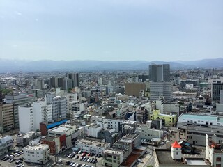 Naklejka premium Scenery of Toyama city and Tateyama mountain range seen from the observation deck of Toyama city