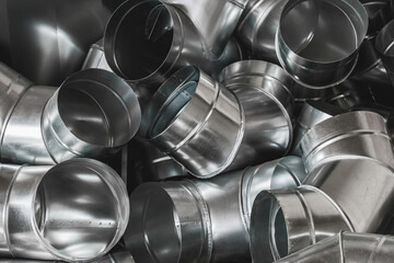 Bends of pipes from galvanized sheet material background. Steel pipe tube on construction site