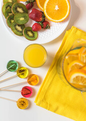 Sugar-free lollipops with dry fruit inside on a background with fresh juicy fruits. Healthy sweetness, benefits of natural fruits