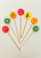 Sugar-free lollipops with dry fruits inside on a white background. Healthy sweetness, benefits of natural fruits