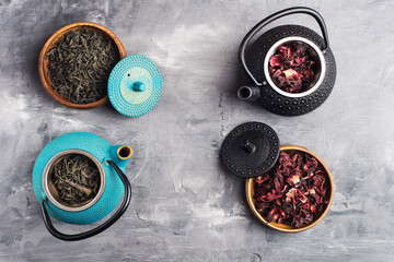 Obraz na płótnie Canvas green and red tea in cast iron teapots.