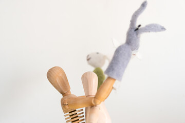 two artist's manikins (mannikins) posing with rabbit and donkey finger puppets
