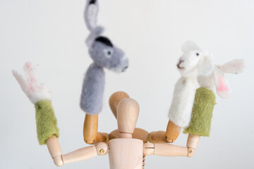 two artist's manikins (mannikins) posing with rabbits, sheep, and donkey finger puppets