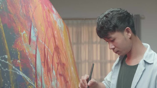 Man Artist Works On Abstract Oil Painting
