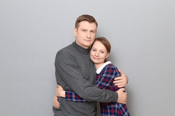 Portrait of couple hugging with pleasure and looking happy