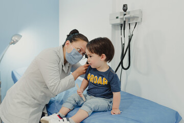 Dr. pediatrician with attending toddler