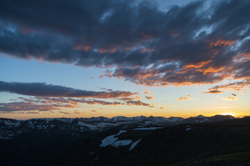 Dramatic colorful sunset and clouds over Rocky Mountain National Park mountain range, Colorado