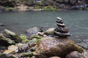 Rock stack next to the water in the forest 3