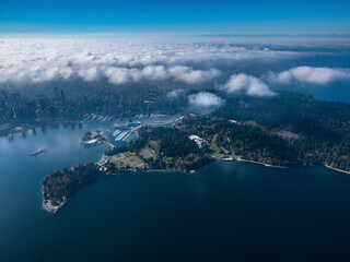 Stock aerial photo of Stanley Park and downtown Vancouver with scattered clouds, Canada