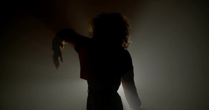 Curly girl silhouette dancing