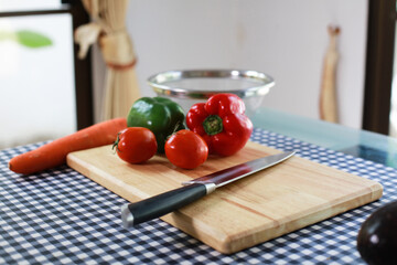 Food and healthy concept, Colorful bell pepper on wooden cutting board and knife