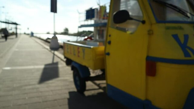 funny and cute three wheeleed car in italy on the dock