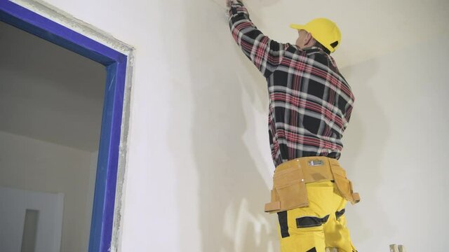 Drywall Ceiling Patching by Remodeling Worker