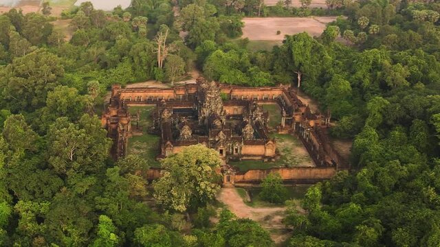 Angkorian temple, Banteay Samre , nested in the mystic lush green Cambodian jungle, aerial drone footage HD crop.