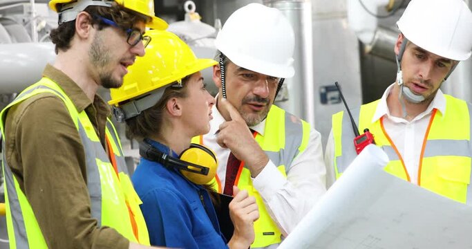 Professional engineer and mechanical team meeting and working together at industry factory workplace. Unity and teamwork concept.