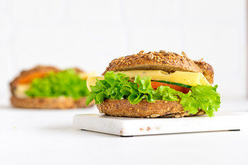 Whole Wheat sandwich with dark bread with Swiss cheese and lettuce isolated 
