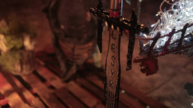 Personalized sword close-up. Mystical symbols and weapons of the northern wild viking barbarians. Pedestal for battles or sacrifices.
