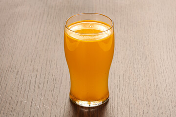 Orange homemade lemonade in the glass