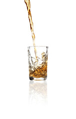 Pouring whiskey into shot glass on white background