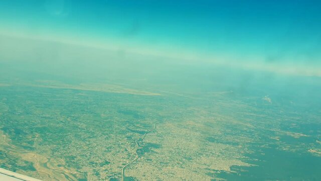 Air view of kashmir to delhi view, top angle of hills snow and mountains. Sky looks blue covered with clouds.