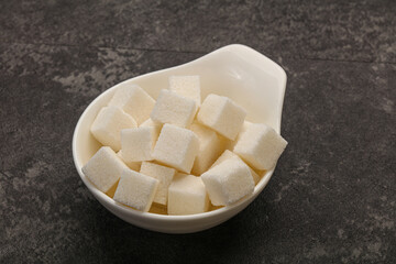 Refined white sugar cubs in the bowl