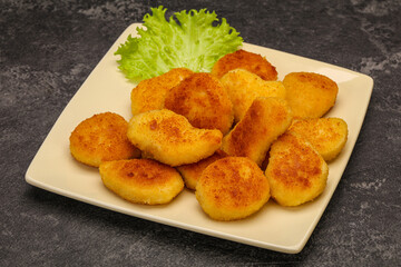 Fried chicken nuggets served salad leaves