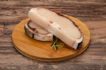 Raw shark steak served rosemary