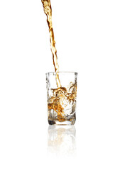 Pouring whiskey into shot glass on white background