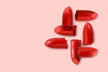 red lipstick bullet on pink pastel color background with copy space for promotion or advertising