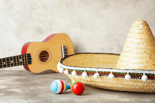 Mexican Sombrero, Guitar And Maracas On Grunge Background