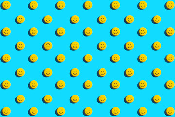Yellow smiley face cookie, food, flat lay, top view, copy space on blue background. Be different.