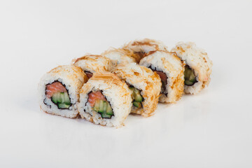 Set of sushi rolls with salmon, cucumber and cream cheese covered with tuna shavings isolated on white background. 