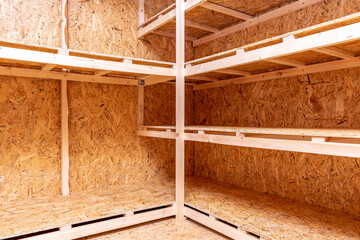 OSB racks, shelves are designed for storing things. Dressing room in the house. Organization of spaces in the house. Shelves in the garage.