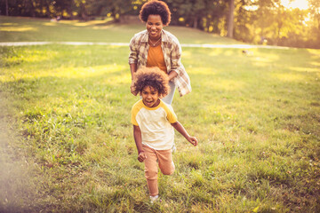 Fototapeta premium Mother and daughter running trough nature.