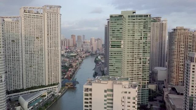 Aerial of the Pasig River and luxury condominiums surrounding both sides of the riverbank. An important waterway in Metro Manila.