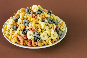 Bunch of Italian green multicolored pasta with tomato and basil flavor