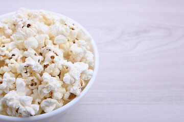 Popcorn in bowl on a red background. Close up. Top view