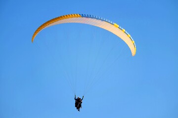 Tandem paragliding with bright sun at Pamukkale in the evening.