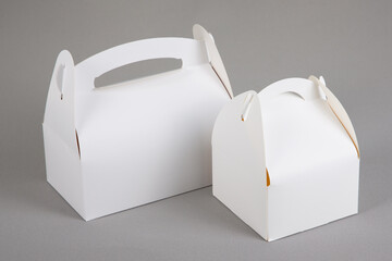 two white blank paper packaging for bakery large and small box with handle in grey background