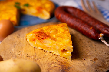 Traditional Spanish omelette cooked with chorizo, potatoes and onion. Traditional tapas of Spanish gastronomy.