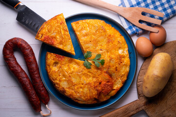 Traditional Spanish omelette cooked with chorizo, potatoes and onion. Traditional tapas of Spanish gastronomy.