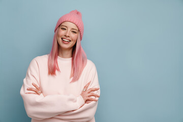 Young white woman with pink hair smiling and posing at camera
