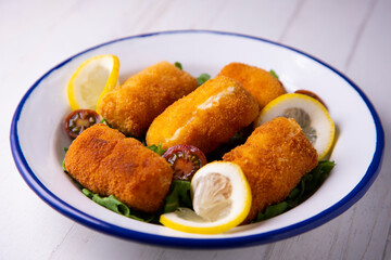 Cod croquettes. Traditional northern spanish tapa in bilbao served with lemon.