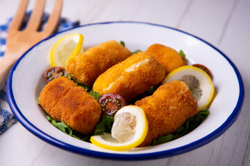 Cod croquettes. Traditional northern spanish tapa in bilbao served with lemon.