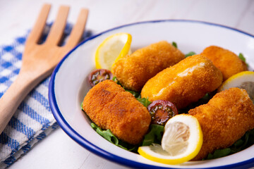 Cod croquettes. Traditional northern spanish tapa in bilbao served with lemon.