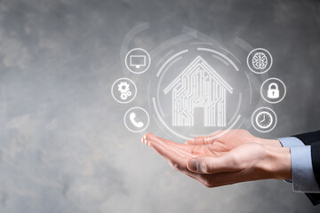 Businessman hold house icon.Smart home controlled, intelligent house, and home automation app...