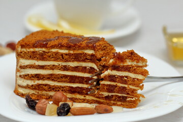 honey cake on a plate with nuts and tea for dessert
